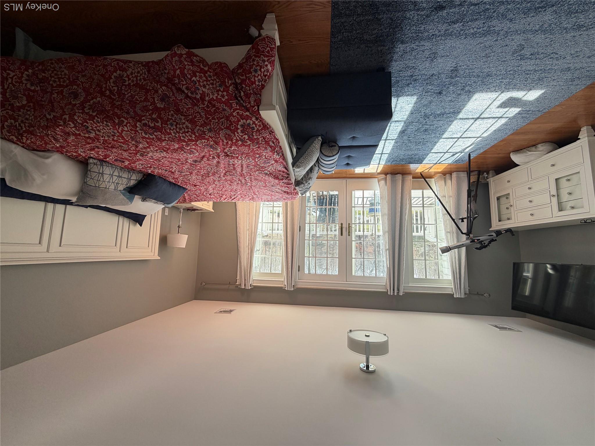 27 Deer Path Quogue, NY 11959 - Photo 37 of 44 a bedroom with a bed couch and a window