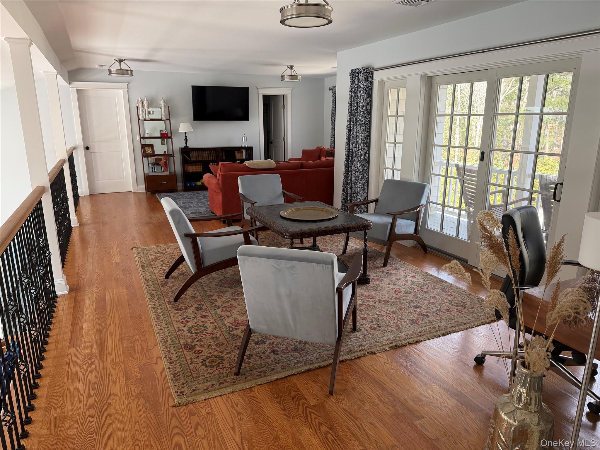 27 Deer Path Quogue, NY 11959 - Photo 4 of 44 a living room with furniture and a flat screen tv