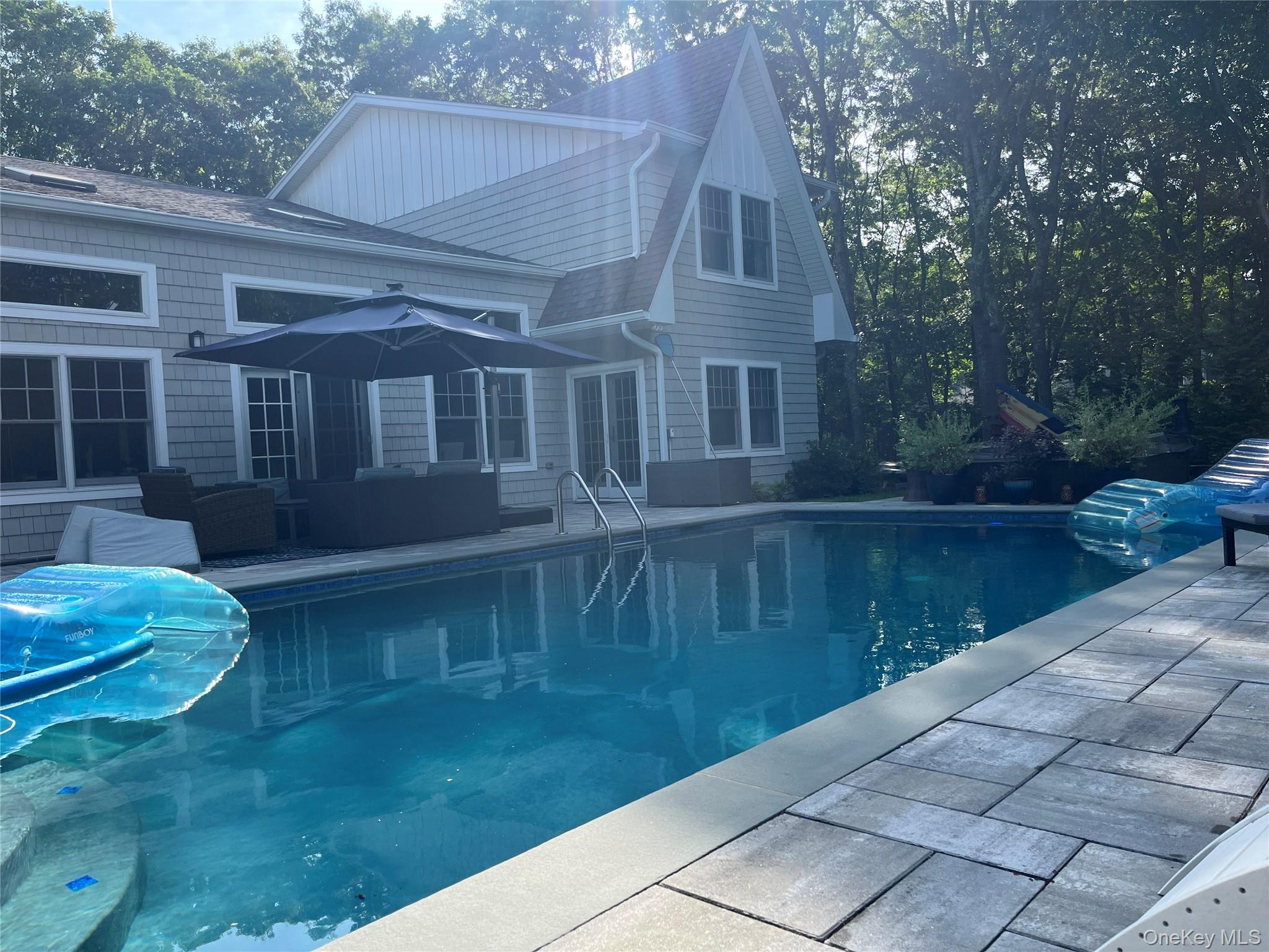 27 Deer Path Quogue, NY 11959 - Photo 43 of 44 a front view of a house with a yard