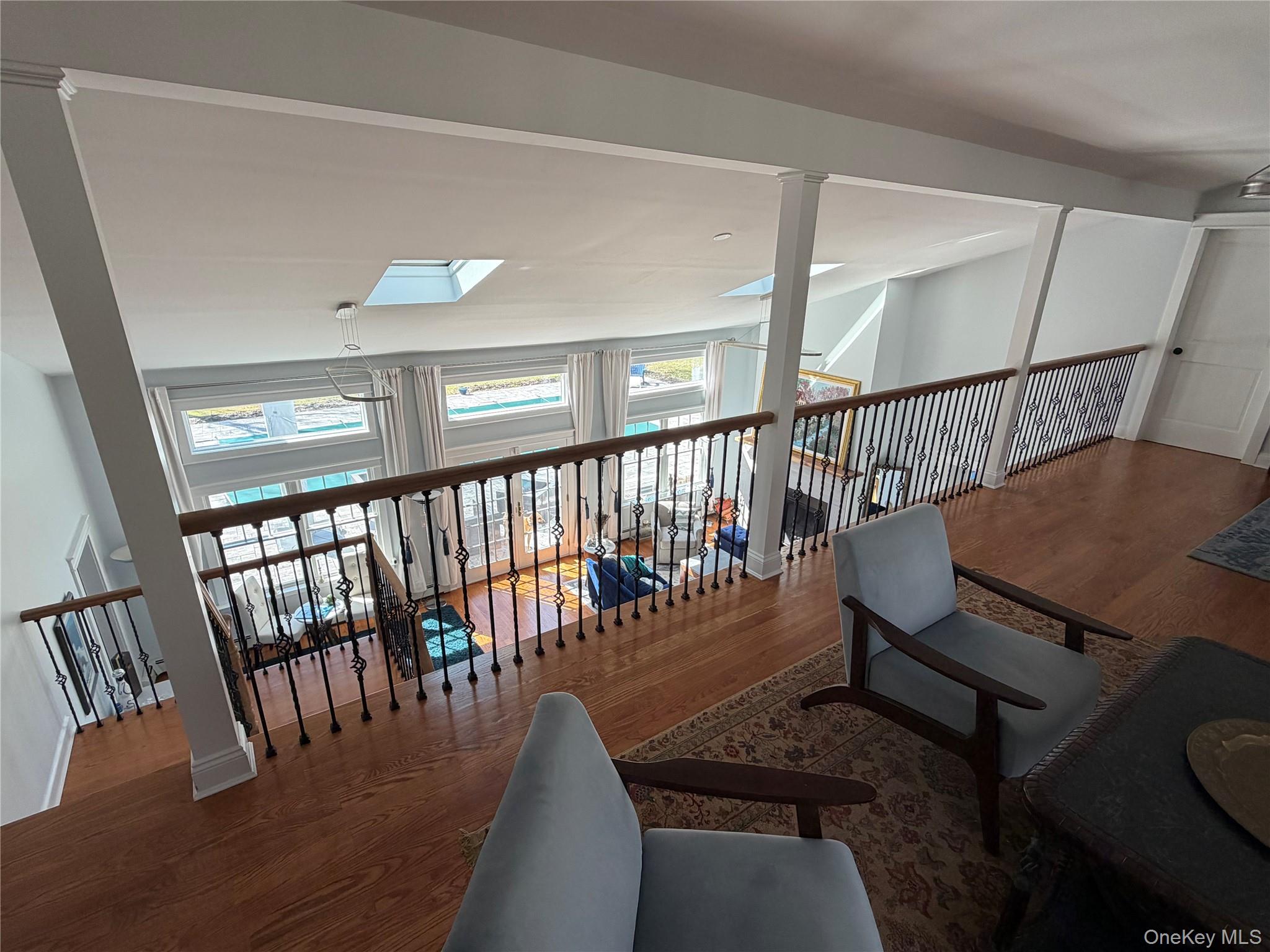 27 Deer Path Quogue, NY 11959 - Photo 6 of 44 a view of a hallway with wooden floor and stairs