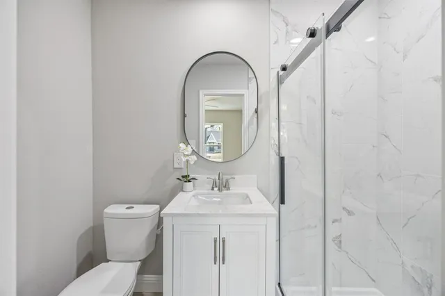 a bathroom with a toilet sink and mirror