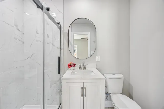 a bathroom with a toilet sink and mirror