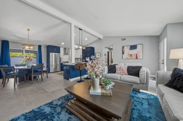 a living room with furniture kitchen view and a dining table