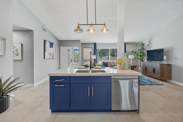 a view of living room with kitchen island furniture and flat screen tv