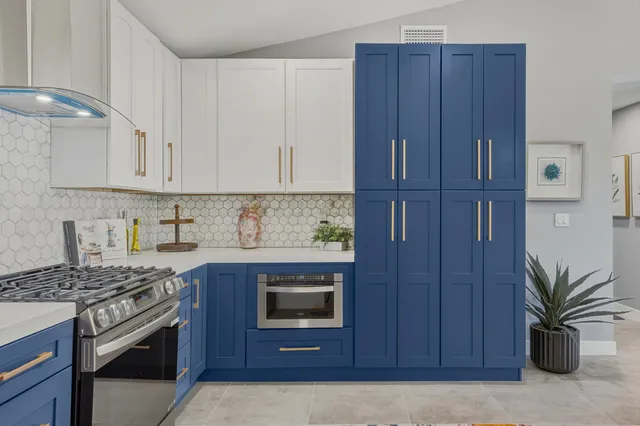 a kitchen with wooden cabinets and a stove top oven