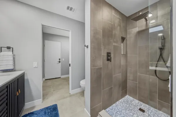 a bathroom with a shower and sink