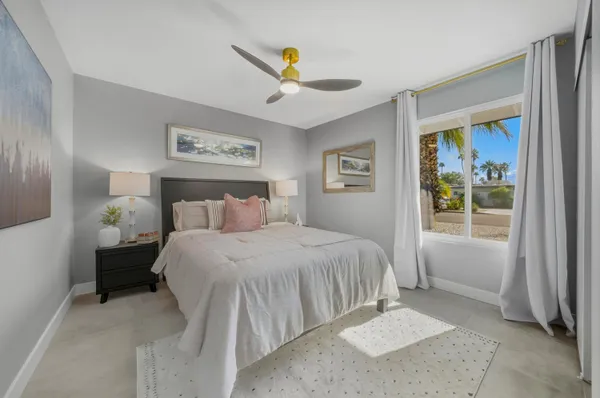 a bedroom with a bed and a painting on the wall