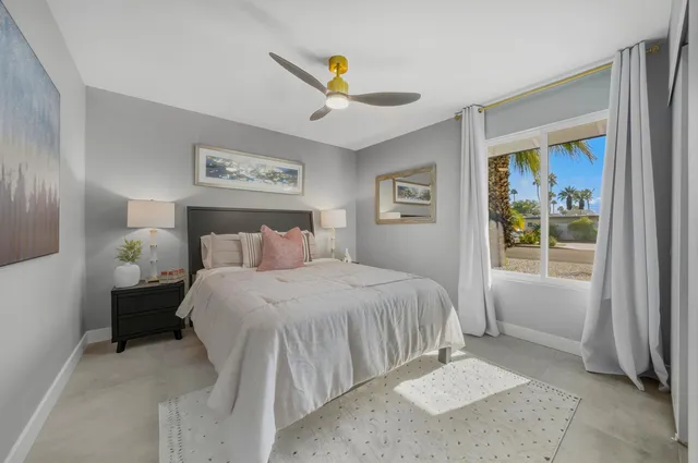 a bedroom with a bed and a painting on the wall