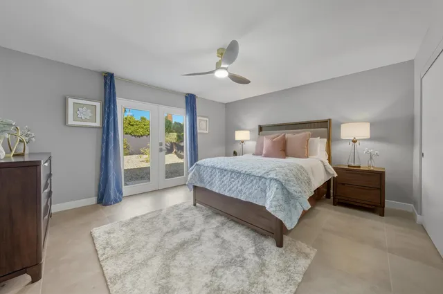 a bedroom with a large bed and a chandelier