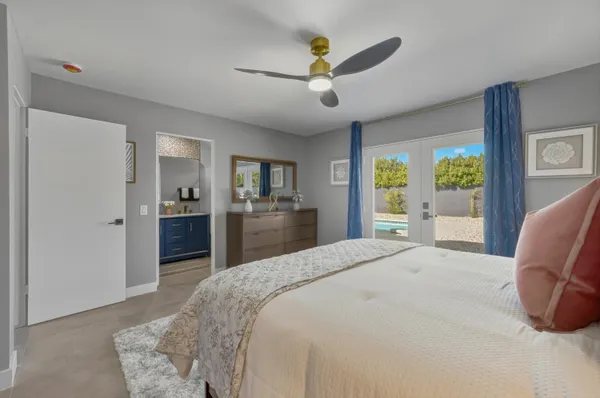 a spacious bedroom with a bed and a view mirror