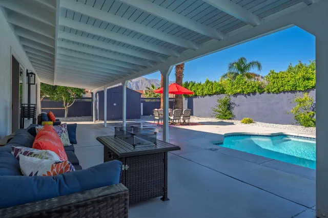 swimming pool view with a seating space