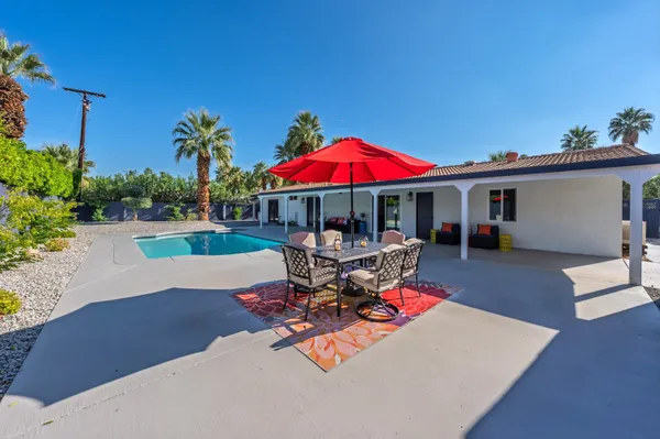 a view of a backyard with sitting area and furniture