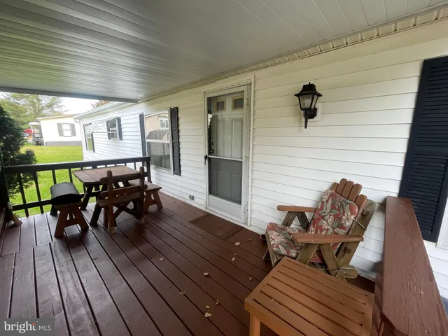 a living room with chairs and wooden floor
