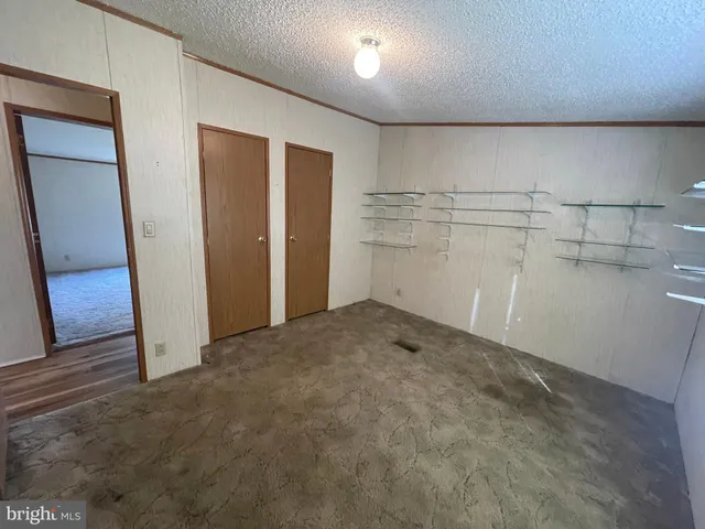a view of storage and utility room with empty racks