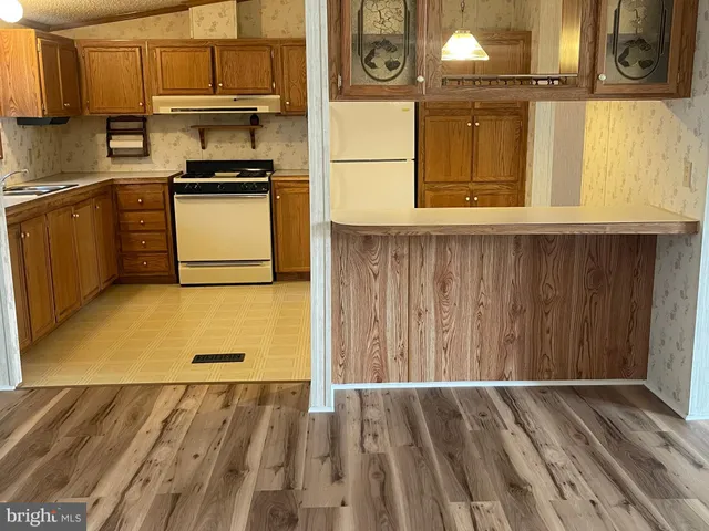a kitchen with wooden cabinets and a stove top oven