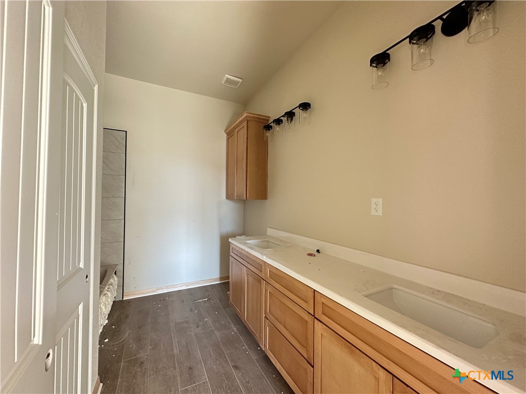 3502 Prato Lane Temple, TX 76502 - Photo 13 of 32 a bathroom with a double vanity sink a toilet and a bathtub