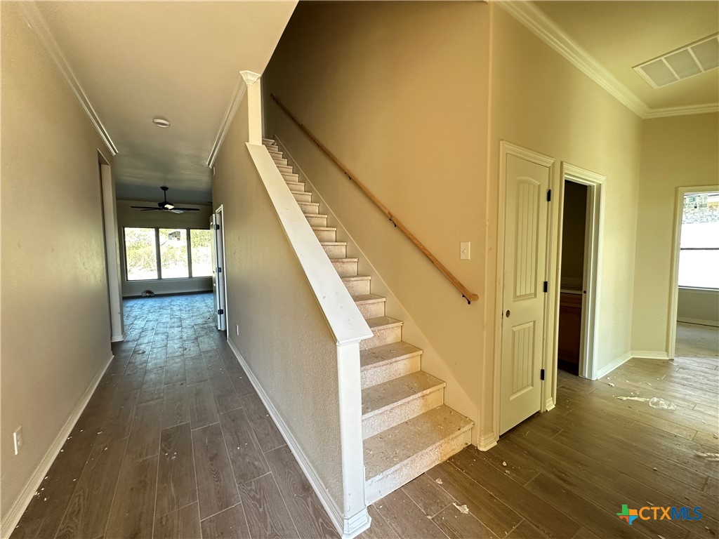 3502 Prato Lane Temple, TX 76502 - Photo 2 of 32 a view of a hallway with wooden floor and staircase
