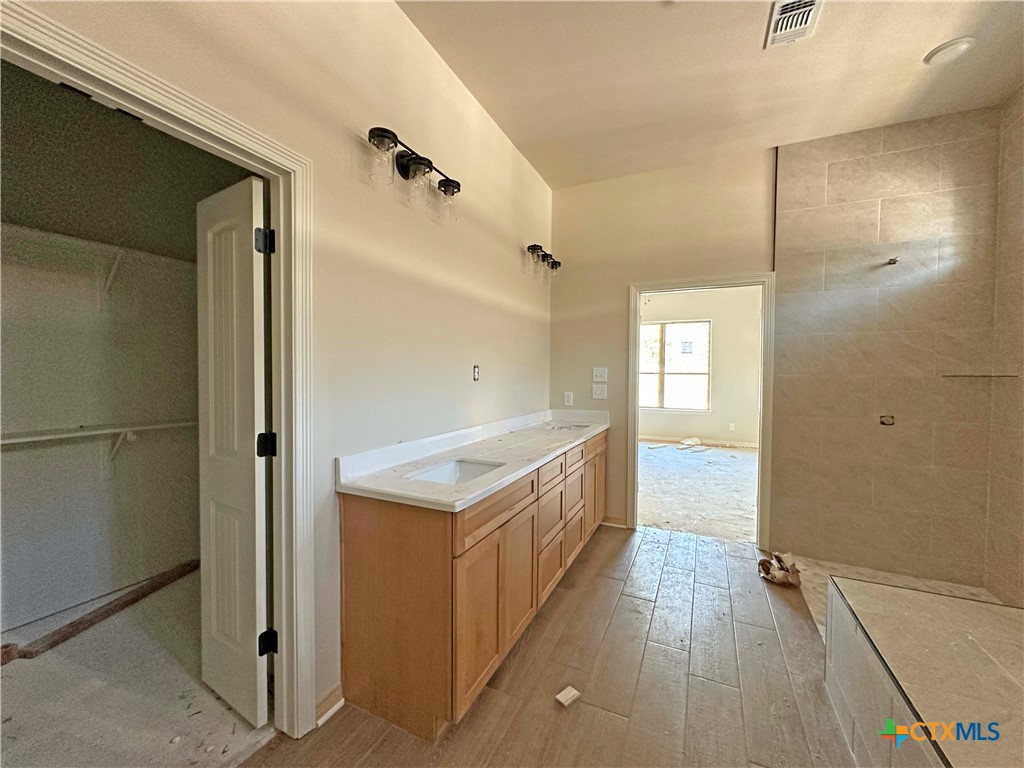 3502 Prato Lane Temple, TX 76502 - Photo 23 of 32 a bathroom with a sink a mirror and a shower