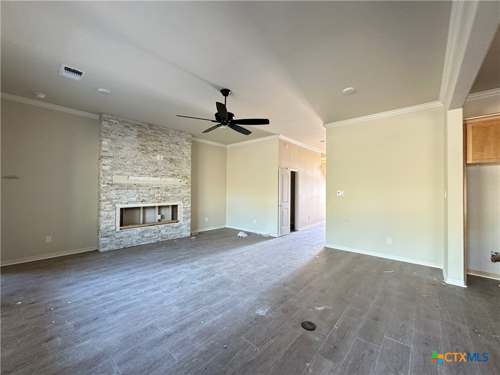 3502 Prato Lane Temple, TX 76502 - Photo 5 of 32 a view of wooden floor and a chandelier fan in an empty room