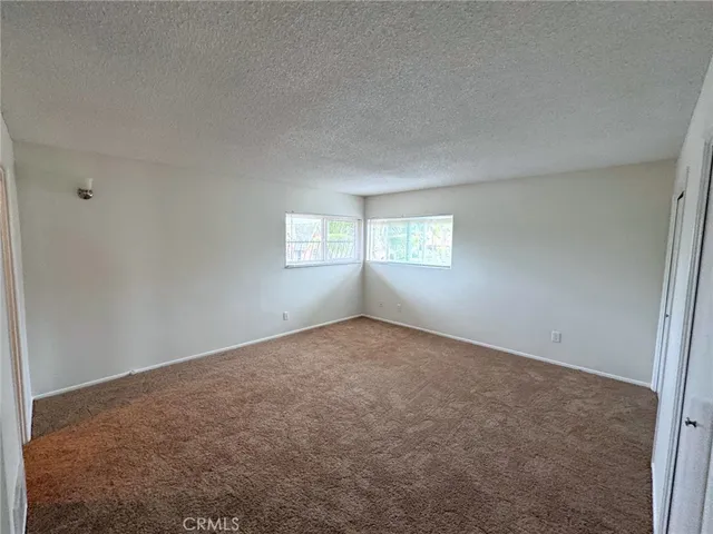a view of an empty room with windows