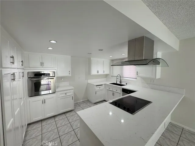 a kitchen with a stove and white cabinets