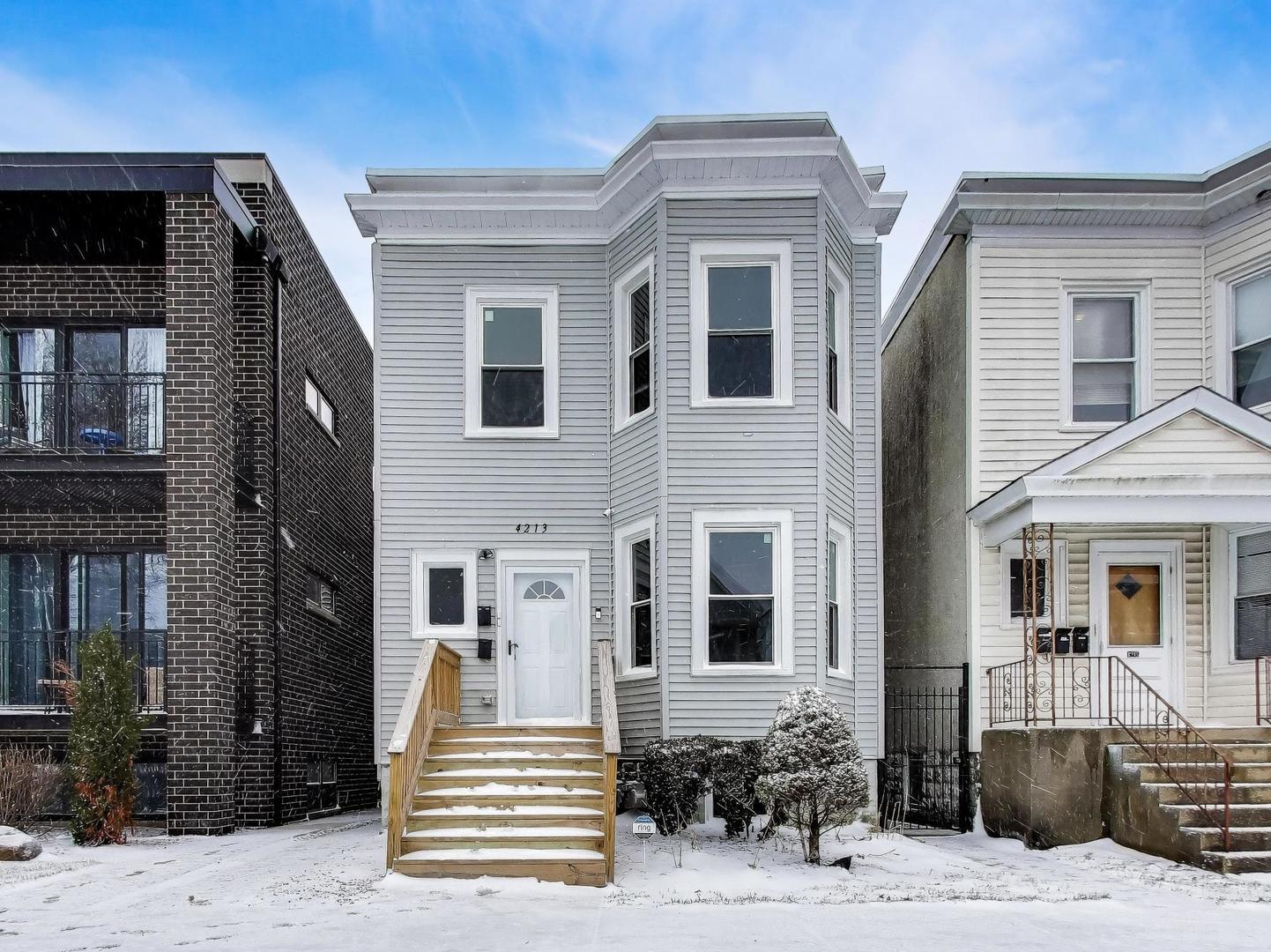 a front view of a house with a chair