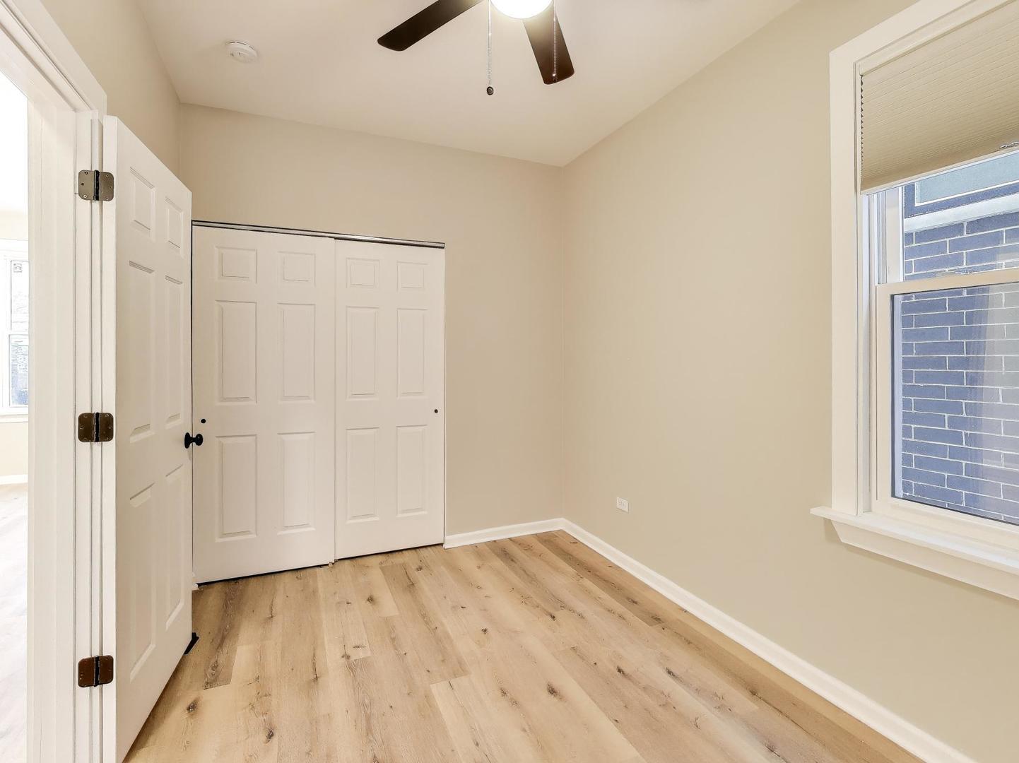 4213 West Roscoe Street, Unit 1 Chicago, IL 60641 - Photo 11 of 15 an empty room with a empty space and windows