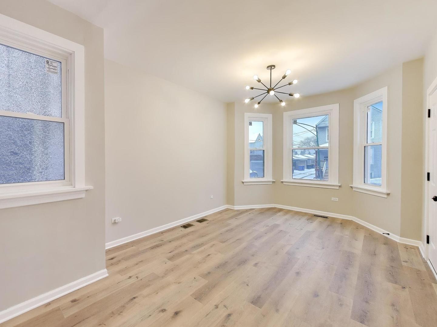 4213 West Roscoe Street, Unit 1 Chicago, IL 60641 - Photo 3 of 15 a view of an empty room with a window