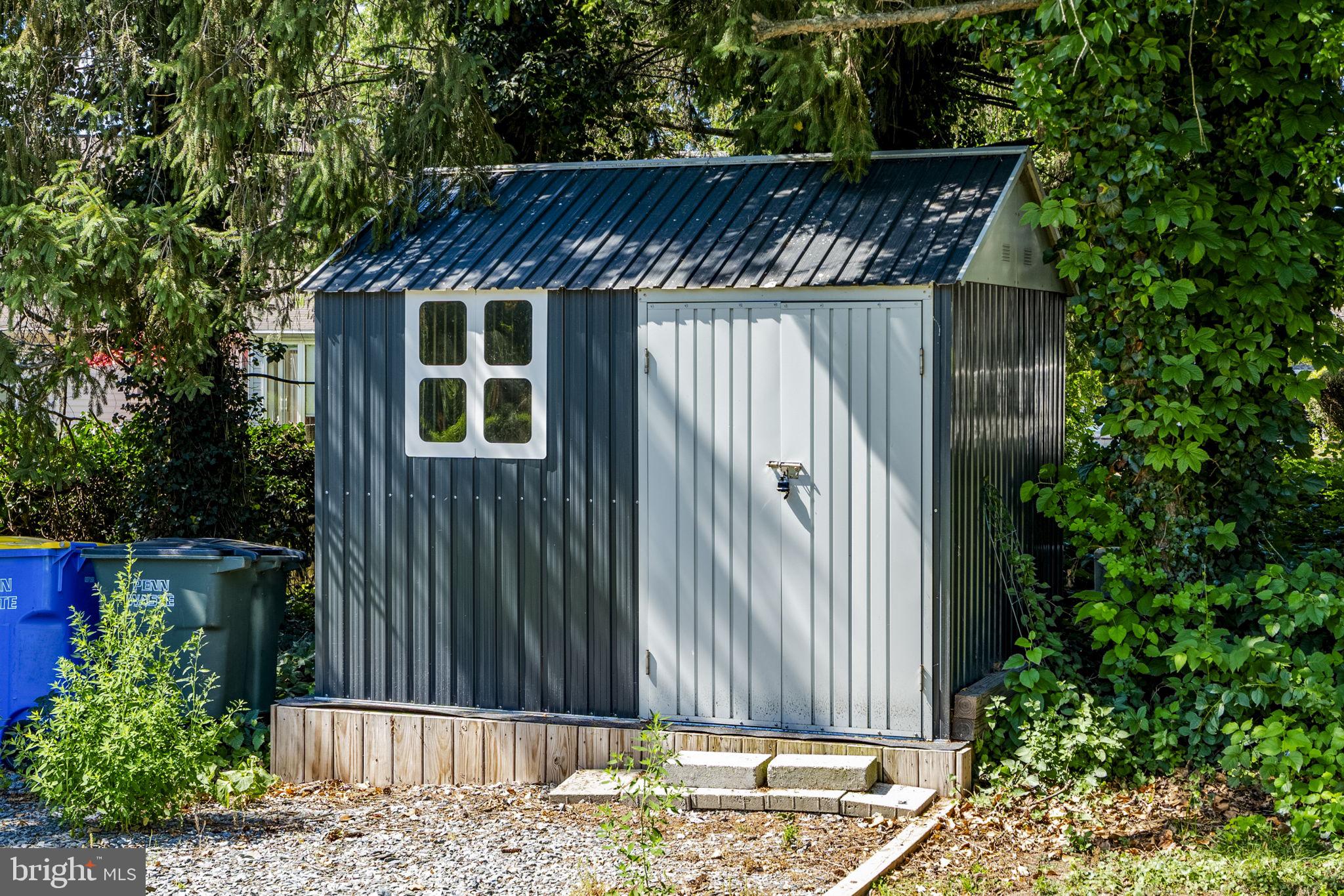 4107 Trowbridge Road York, PA 17402 - Photo 46 of 50 Charming garden shed nestled in greenery.