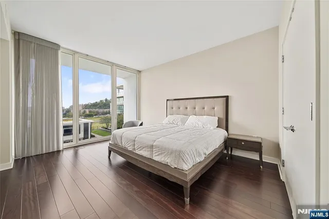 a bedroom with a bed and a large window