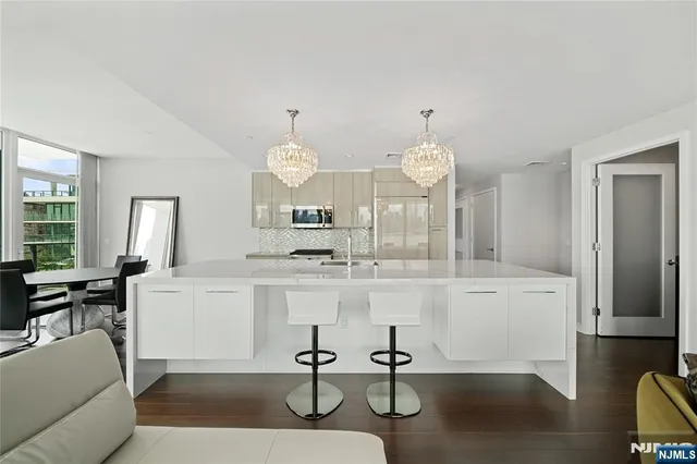 a view of living room kitchen with furniture and fireplace