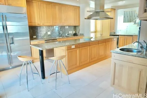 a kitchen with stainless steel appliances granite countertop a refrigerator a stove a sink and dishwasher