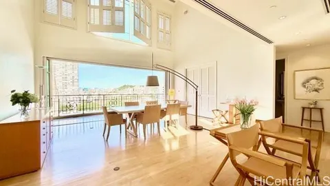 a view of a living room with a table and chairs
