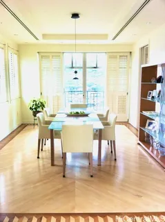 a dining room filled with furniture and wooden floor