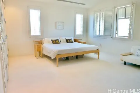 a large white bathroom with a large tub sink and window