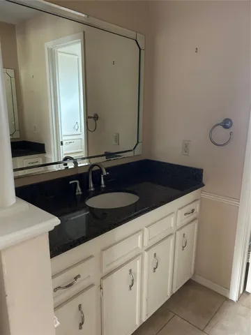 a close view of a sink and dishwasher with kitchen island