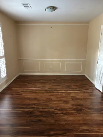 a view of a room with wooden floor