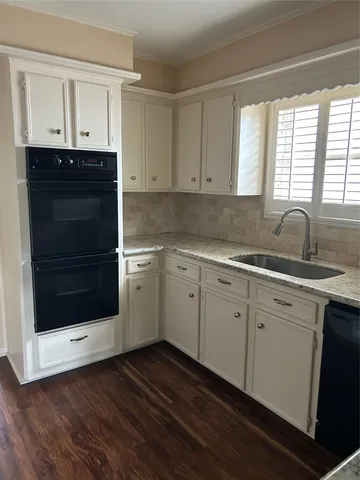 a kitchen with stainless steel appliances white cabinets and a sink