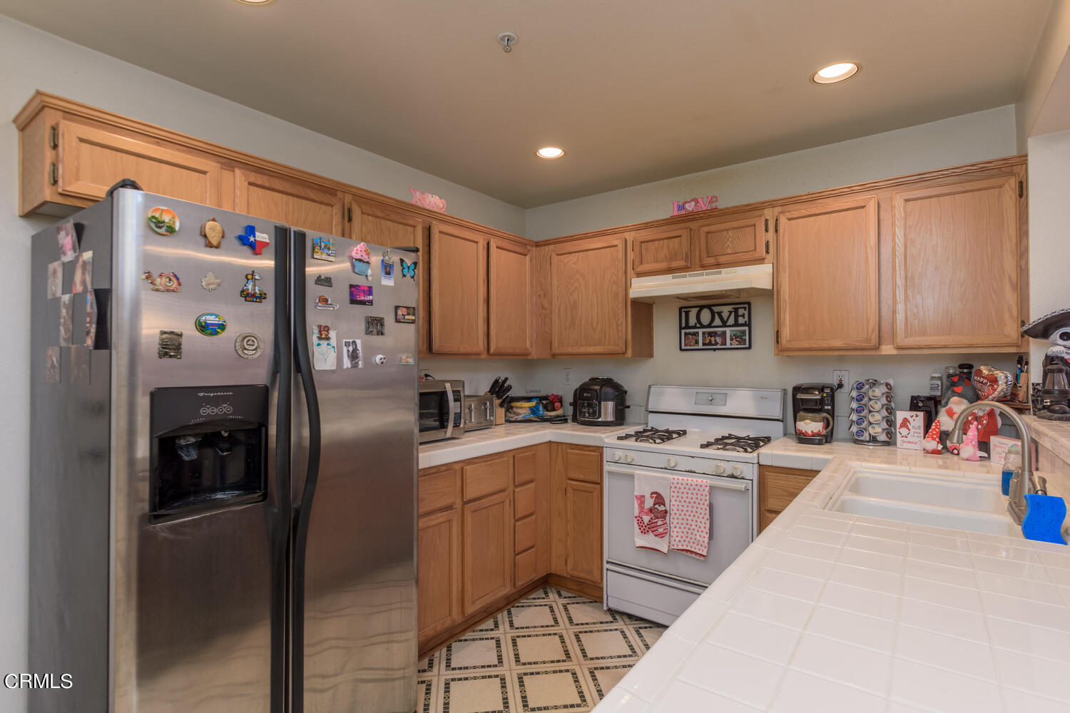 751 Kingfisher Way Oxnard, CA 93030 - Photo 8 of 22 a kitchen with stainless steel appliances granite countertop a refrigerator sink and cabinets