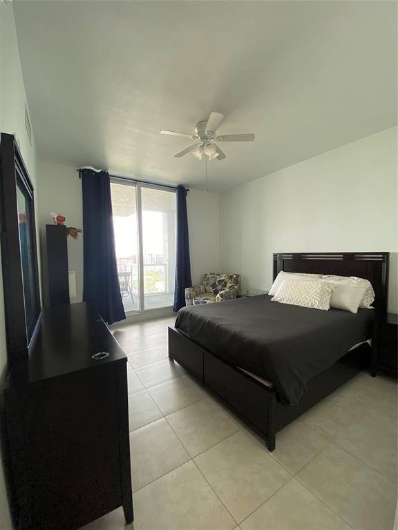 315 Northeast 3rd Avenue, Unit 1509 Fort Lauderdale, FL 33301 - Photo 16 of 40 a spacious bedroom with a bed and a television