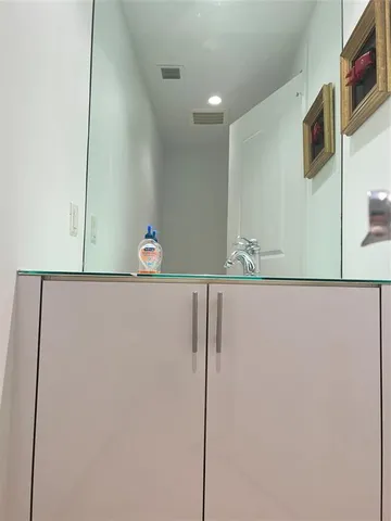 a white toilet sitting next to a bathroom sink