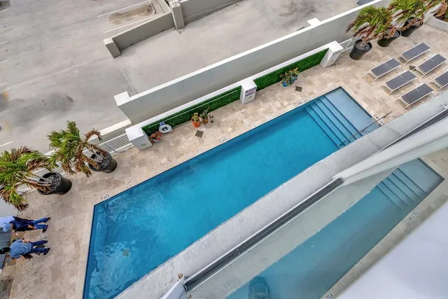 a view of a patio with chairs and potted plants