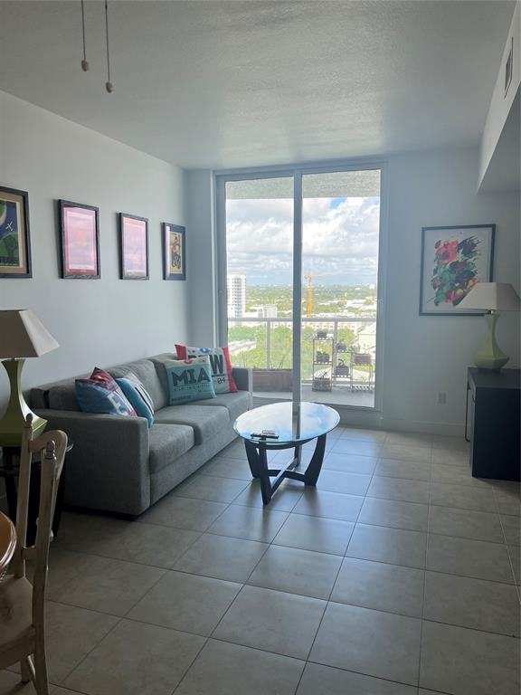 315 Northeast 3rd Avenue, Unit 1509 Fort Lauderdale, FL 33301 - Photo 8 of 40 a living room with furniture and a large window
