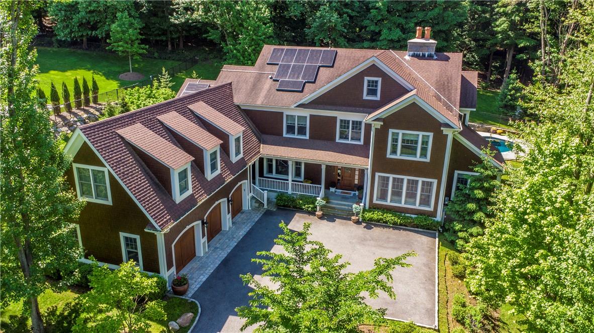 Welcome to 54 Gracemere! Stunning curb appeal with a rare 3-car garage equipped with two Tesla charging stations.