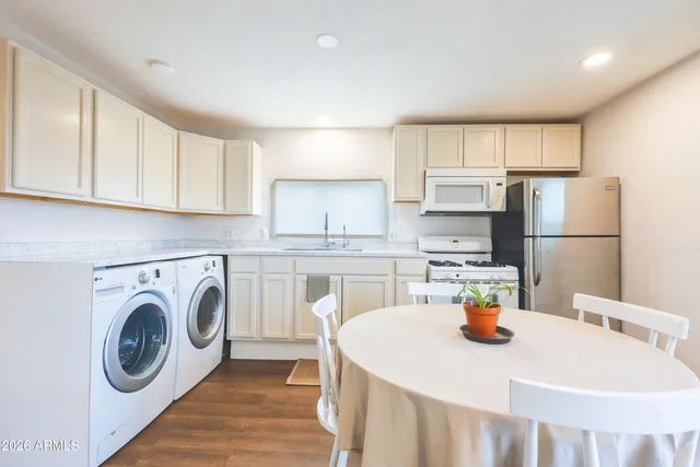 a living room with furniture dining table and a potted plant