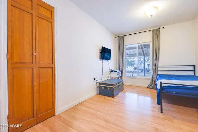 a bedroom with furniture and a window