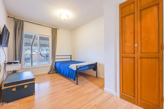 a bedroom with a bed and cabinet