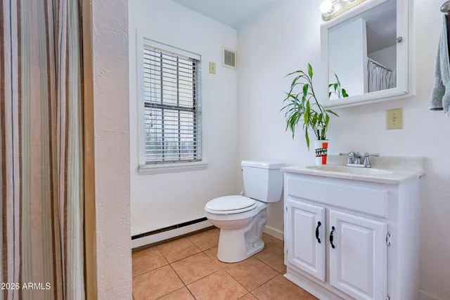 a white toilet sitting next to a window