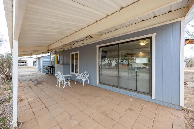 a view of a porch with table and chairs