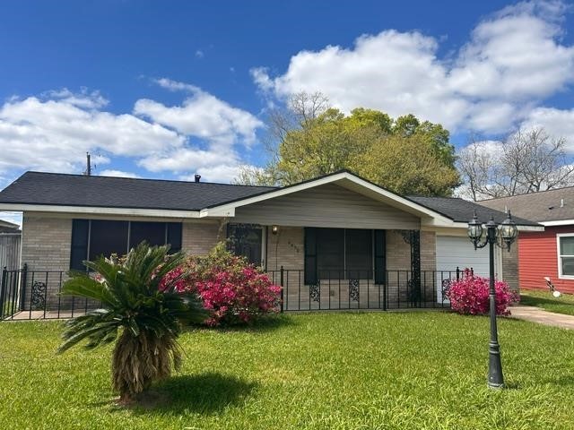 4420 Raven Street Beaumont, TX 77705 - Photo 1 of 11 a front view of a house with garden